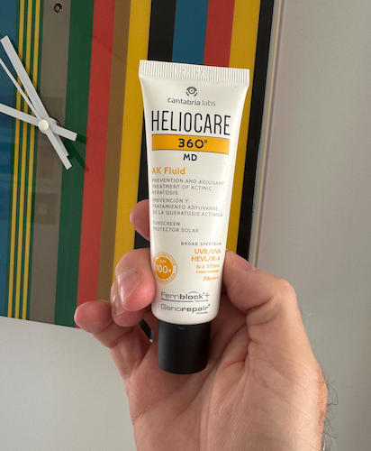 A product bottle and box for Heliocare 360° MD AK Fluid SPF100+.